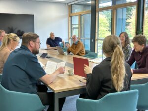 People laughing in office board room